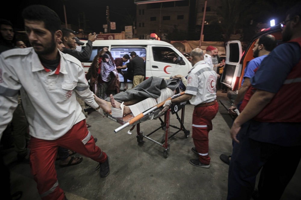 Injured Palestinians arrive at Nasser Hospital in Khan Younis, in the southern Gaza Strip, on Tuesday.