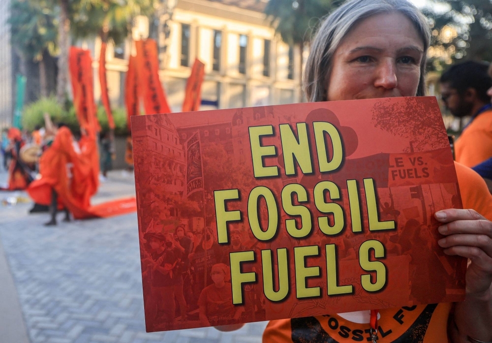 Activists protest against fossil fuels on the sidelines of the COP28 climate summit in Dubai on Tuesday.