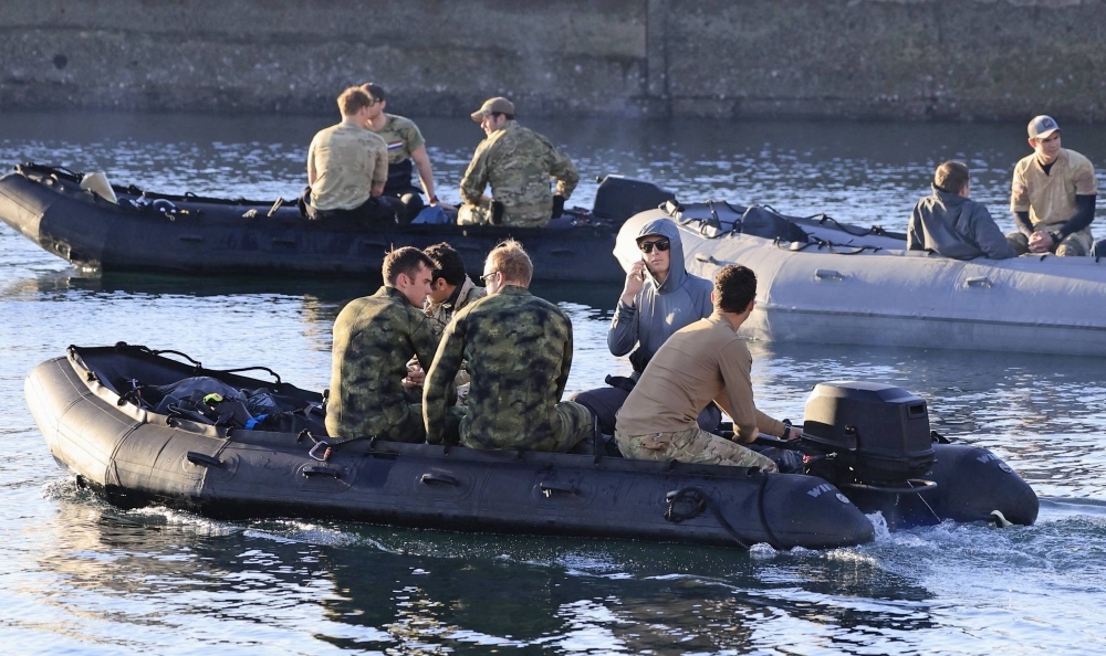 U.S. military officers on boats depart the Anbo Port on Yakushima Island, Kagoshima Prefecture, on Wednesday.