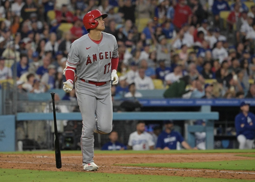 Los Angeles Angels designated hitter Shohei Ohtani hits a three-run home run against the Los Angeles Dodgers at Dodger Stadium in July. 
