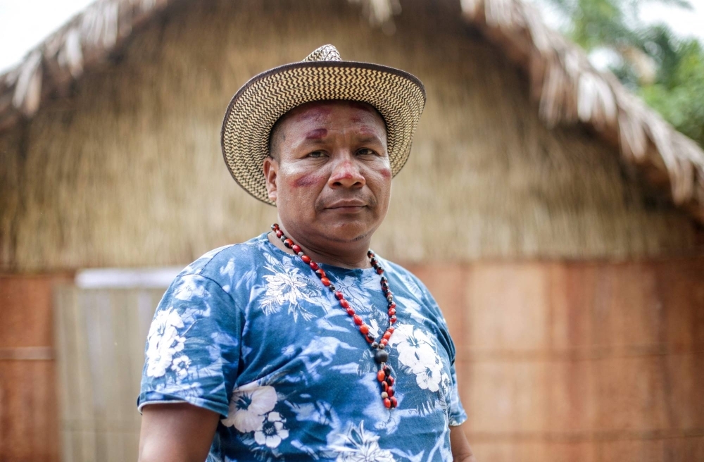 Indigenous leader Fabio Valencia poses for a picture near the Pira Parana River in Vaupes province, Colombia. Far from the COP28 in Dubai, where carbon credits are discussed as a solution to the climate crisis, Valencia says that the sales of these 'green' bonds to polluting companies 'are worse' for indigenous traditions than mining and oil exploitation.