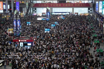 People wait to board trains at the Hongqiao railway station in Shanghai ahead of the National Day holiday on Sept. 28. 