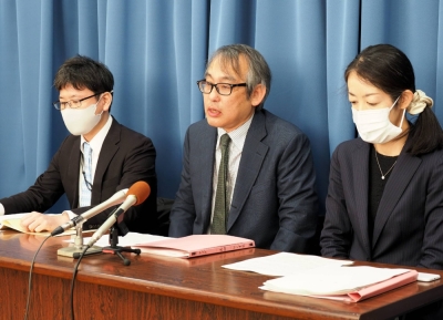 Lawyers representing a consumer advocacy group speak to reporters on Wednesday after filing a cease and desist lawsuit against online travel agency Agoda.