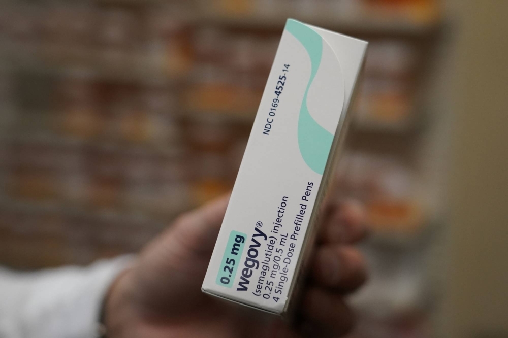 A pharmacist holds a box of Novo Nordisk A/S Wegovy brand semaglutide medication.