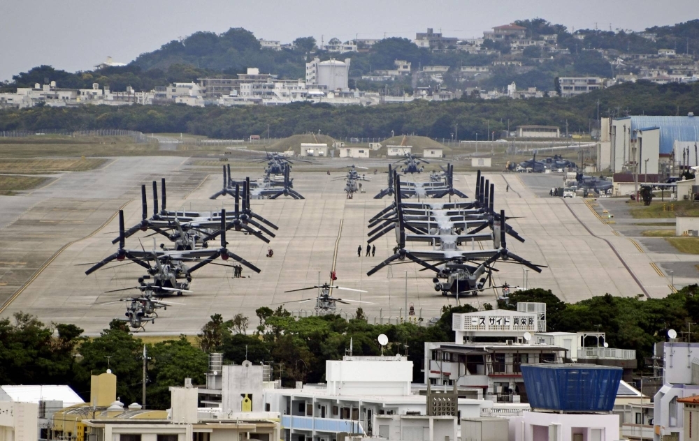 U.S. military Ospreys and helicopters are lined up on a runway at the U.S. Marine Corps Air Station Futenma in Ginowan, Okinawa Prefecture, on Dec. 1 