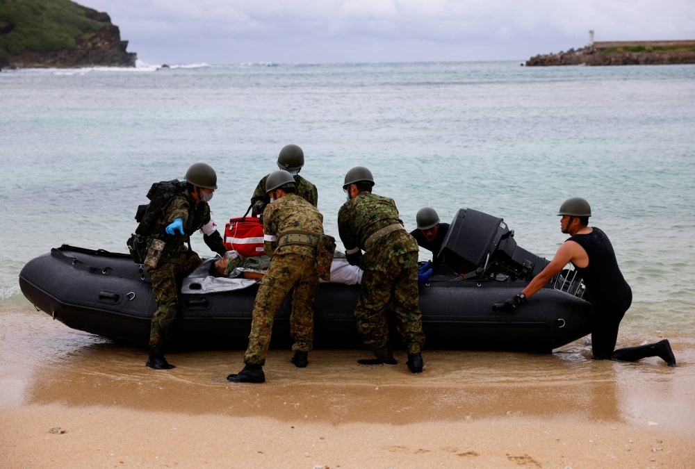 Self-Defense Forces personnel take part in an evacuation drill on Yonaguni, Japan's westernmost inhabited island, in Okinawa prefecture on Nov.12.