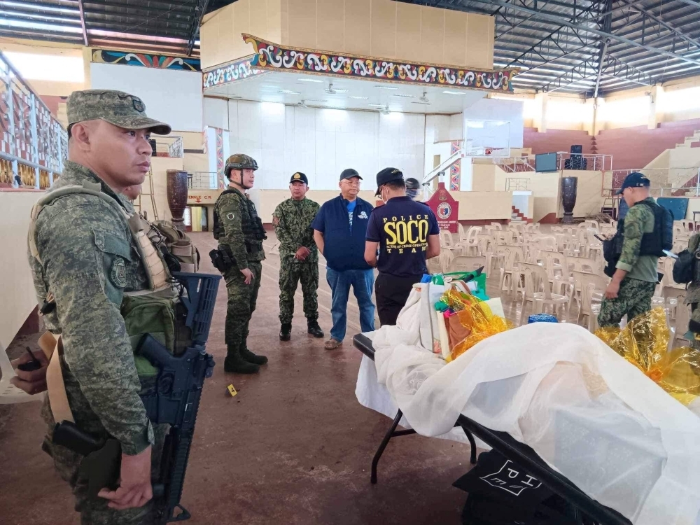 Local government and law enforcement officials view the scene of an explosion that occurred during a Catholic mass in a gymnasium at Mindanao State University in Marawi, Philippines, on Sunday.