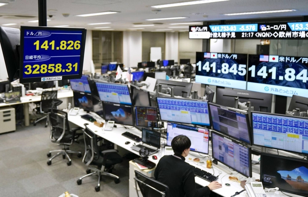 A monitor at a foreign exchange transaction firm in Tokyo shows the yen strengthening to ¥141 to the dollar early Friday. Comments from BOJ Gov. Kazuo Ueda on Thursday, along with remarks from one of his deputies on Wednesday, jolted financial markets in Tokyo and globally. 