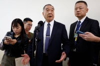 Taiwanese Defense Minister Chiu Kuo-cheng (center) speaks to the media on Friday, a day after a Chinese balloon was spotted crossing the median line of the Taiwan Strait. | Reuters