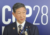 Japanese Environment Minister Shintaro Ito speaks to reporters in Dubai on Saturday during COP28.  | KYODO 