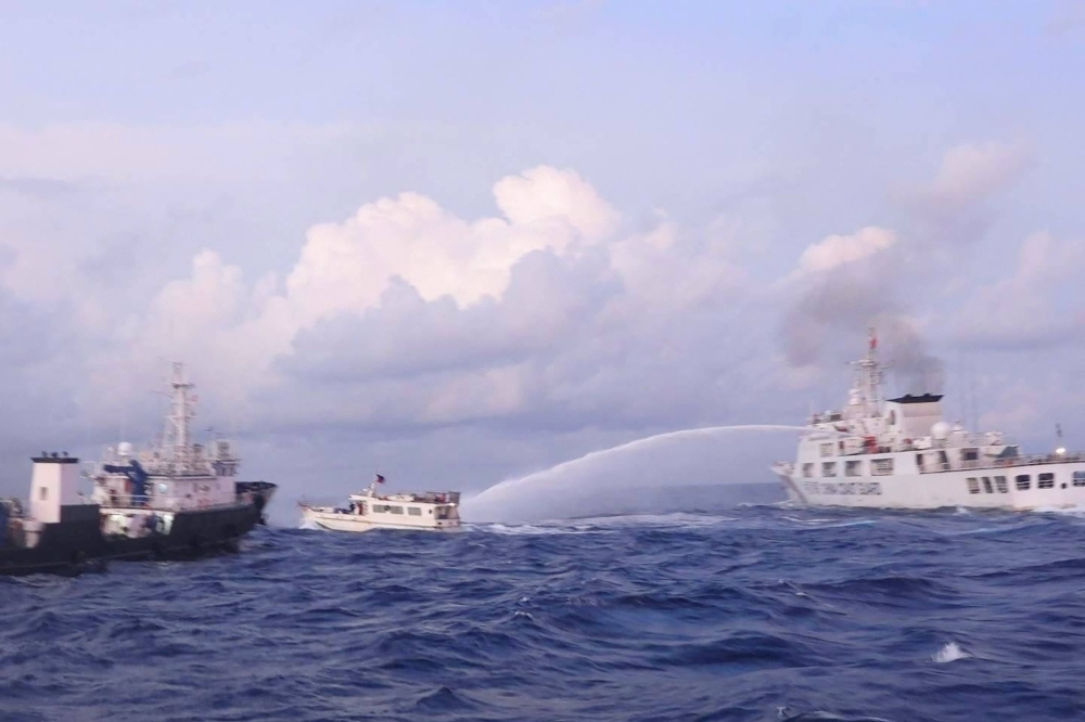 A China Coast Guard vessel fires a water cannon at a Philippine supply boat during a mission to deliver provisions to the Second Thomas Shoal in disputed waters of the South China Sea on Sunday.