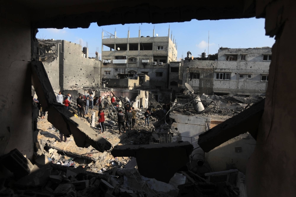 Local men survey the damage after an Israeli airstrike on Khan Younis, in southern Gaza, on Dec. 1.