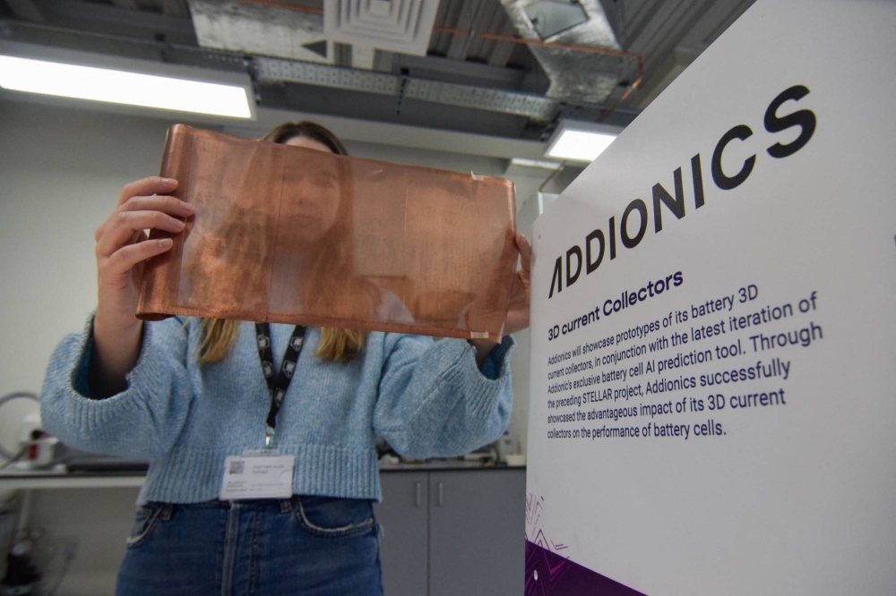 Bernadett Vejkey, marketing manager at Addionics, holds up a sheet of a porous, three-dimensional copper anode the battery materials startup has developed for electric vehicle batteries, at the company's lab in London.