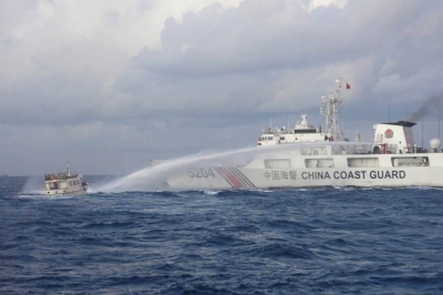 A China Coast Guard vessel uses a water cannon against a Philippine supply boat as it carries out a mission to deliver provisions to the Second Thomas Shoal in the disputed South China Sea on Sunday.