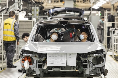 Nio workers inspect a vehicle on an assembly line at the automaker’s factory in Hefei, China. China misjudged the rapid expansion of its electric vehicle sector, leaving a shortfall of skilled technicians as young people shun manufacturing careers. 