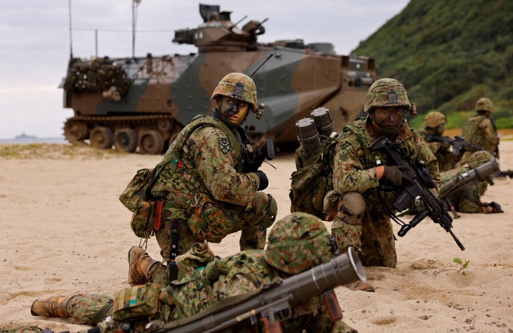 Ground Self-Defense Force soldiers on Tokunoshima island, Kagoshima Prefecture, on Nov. 19. The government plans to secure over ¥1 trillion in fresh defense outlays by raising corporate, tobacco and income taxes in stages, but it has yet to decide when to start increasing the taxes.