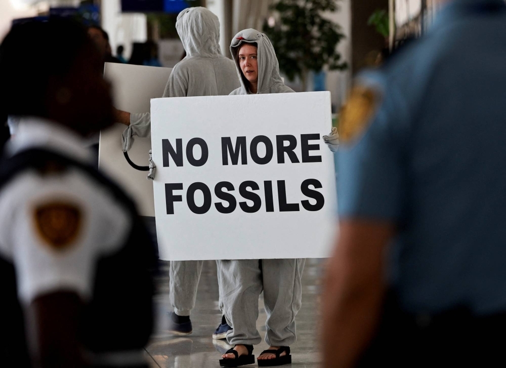 An activist attends a protest at COP28 in Dubai on Monday.