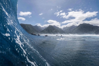 Surfers wait for waves in Teahupo'o, Tahiti, French Polynesia, on Aug. 9.