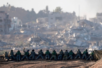Israeli soldiers keep position on a hill overlooking northern Gaza on Monday.
