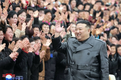 North Korea's leader Kim Jong Un waves as he takes poses for photos during the Fifth National Mothers' Convention in Pyongyang.