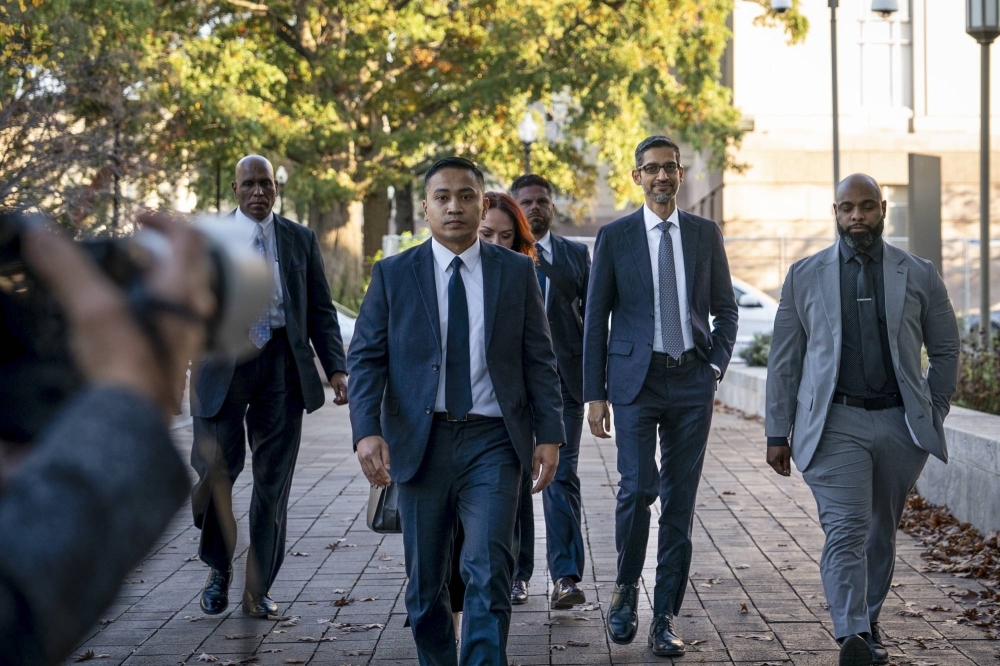Sundar Pichai, Google's chief executive (right), arrives to testify at an antitrust case against Google in Washington on Oct. 30. A trio of antitrust cases on the docket threaten to reshape Google’s business and sap its profits.