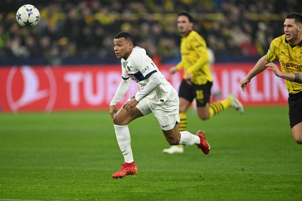 Paris Saint-Germain forward Kylian Mbappe vies for the ball during the team's Champions League group match against Borussia Dortmund in Dortmund, Germany, on Wednesday. 