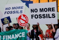 Climate activists protest against fossil fuels at Dubai's Expo City during the United Nations Climate Change Conference COP28 in Dubai on Tuesday. | REUTERS