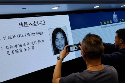 The image of activist Frances Hui is displayed during a news conference to issue arrest warrants in Hong Kong on Thursday.