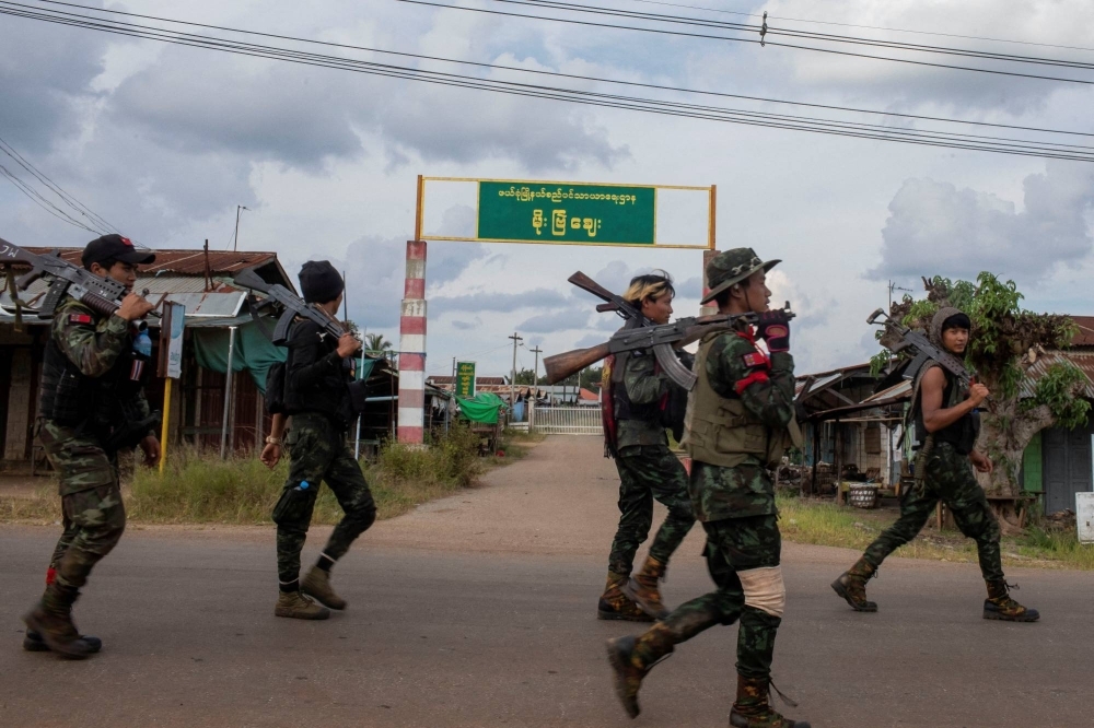Volunteer members of Karenni insurgent forces patrol in Moe Bye in Kayah State, Myanmar, in November.