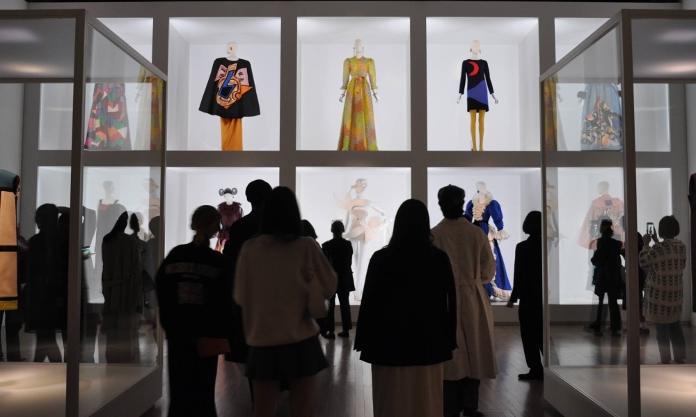 Visitors in the last gallery of “Yves Saint Laurent, Across the Style” at the National Art Center, Tokyo, view designs inspired by fine art.
