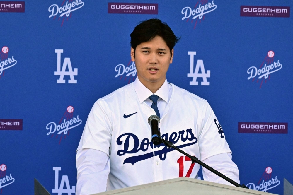 Baseball player Shohei Ohtani speaks during a news conference on his presentation after signing a 10-year deal with the Los Angeles Dodgers at Dodgers Stadium in Los Angeles, California, on Thursday.