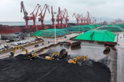 Diggers move piles of coal after it was unloaded from a ship at Lianyungang Port in China's Jiangsu province. 