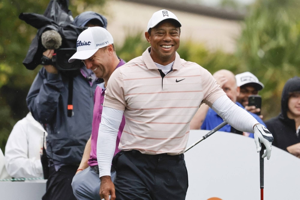 Tiger Woods laughs at a comment made by Justin Thomas (back) during the PNC Championship in Orlando, Florida, on Saturday. 