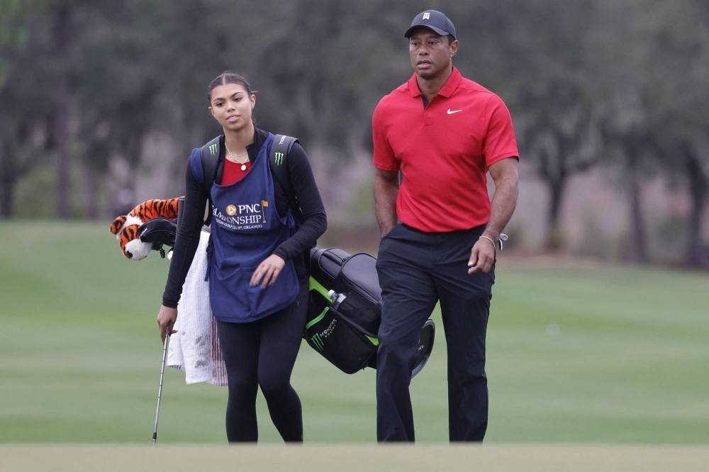Tiger Woods walks onto the 18th green with his daughter Sam Woods during the PNC Championship at The Ritz-Carlton Golf Club in Orlando, Florida, on Sunday.