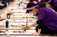 A participant writes during a New Year calligraphy contest in Tokyo on Jan. 5, 2023. | REUTERS