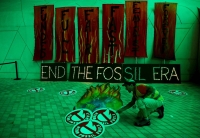 A climate activist arranges artwork expressing opposition to fossil fuels at Dubai's Expo City during the United Nations Climate Change Conference COP28 in Dubai on Dec. 12. | REUTERS