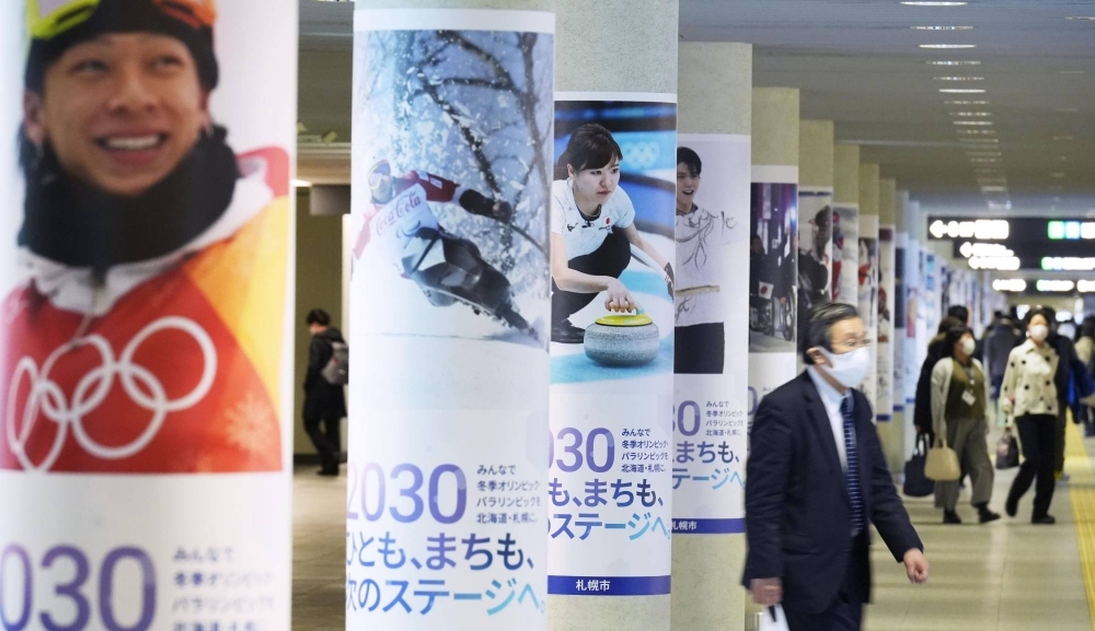 Posters to promote Sapporo's bid to host the 2030 Winter Olympics and Paralympics are seen in an underground shopping arcade in the city in February 2022.
