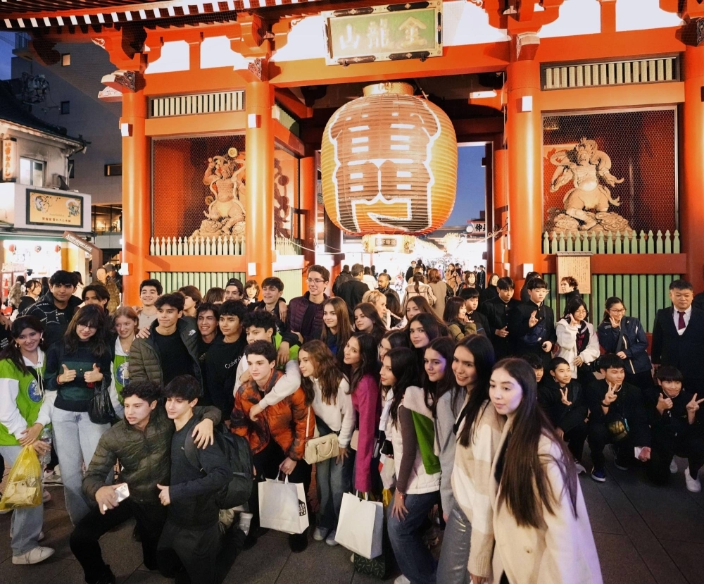 Foreign tourists take pictures in Tokyo's Asakusa district in November.