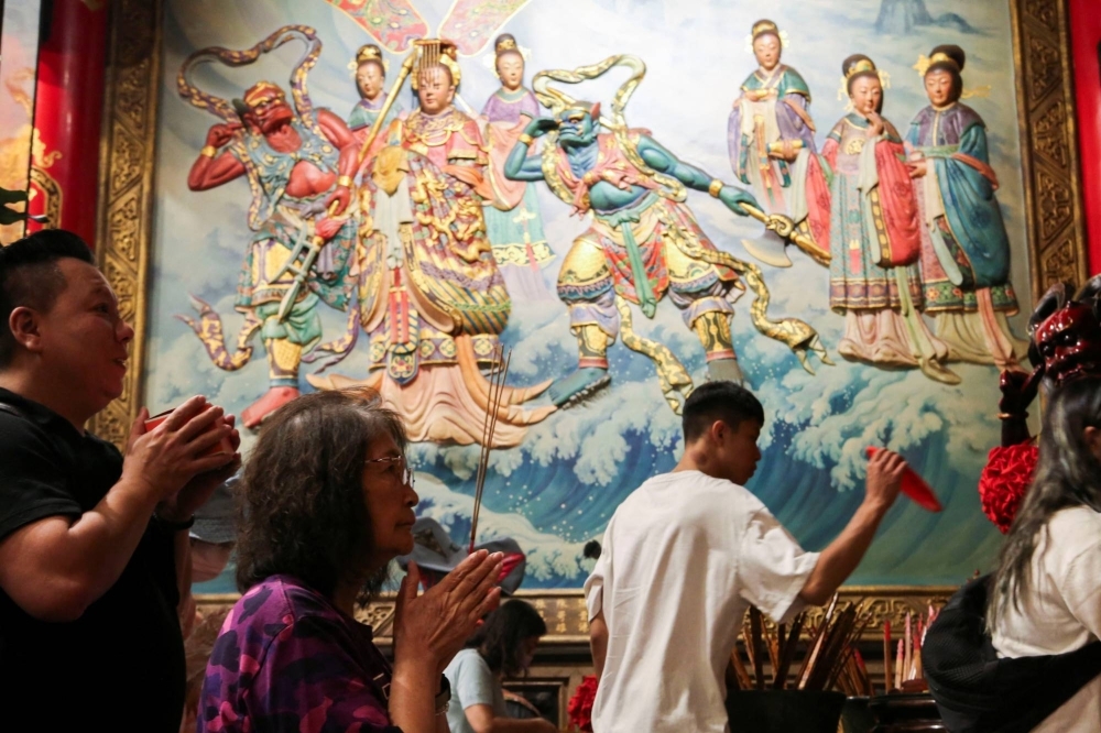 Worshipers pray to the sea goddess Mazu at the Dajia Jenn Lann Temple in Taichung, Taiwan, on Nov. 9.