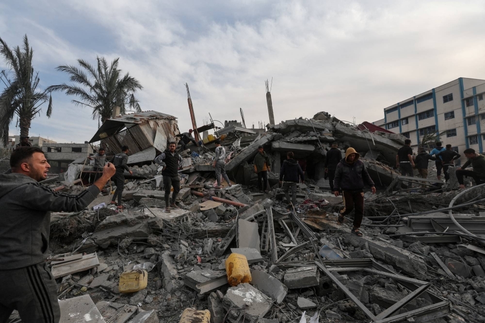 Palestinians search for casualties at the site of an Israeli strike on a house in the southern Gaza Strip on Wednesday.