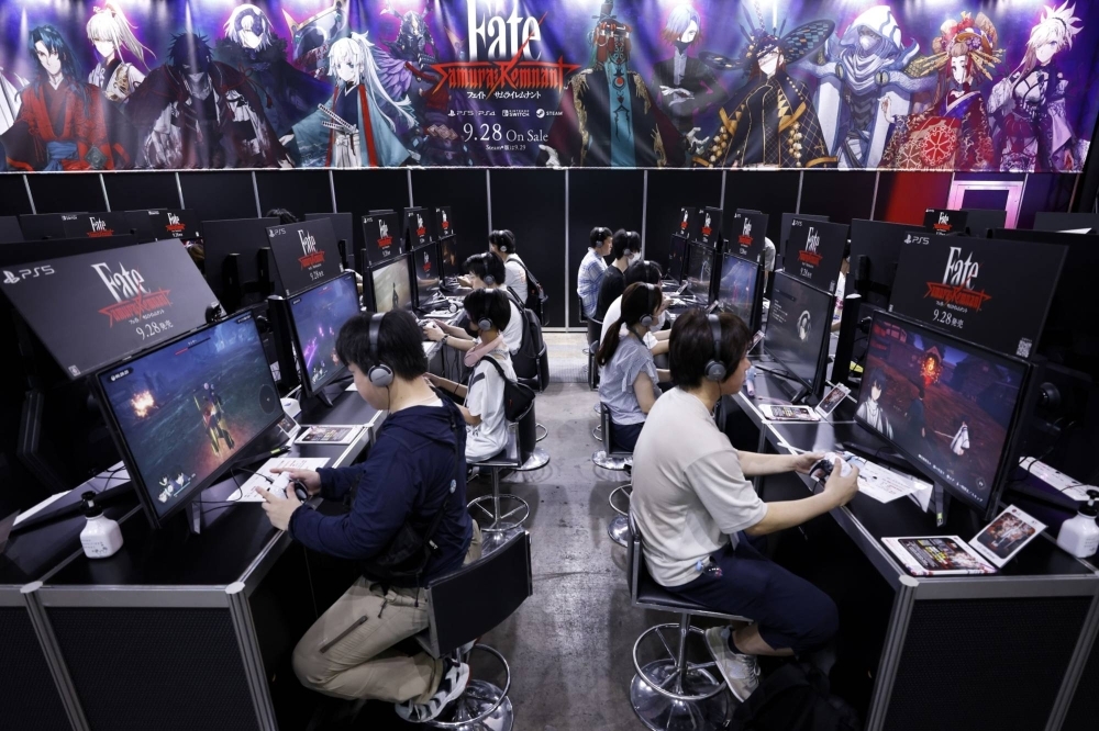 Attendees play the Fate/Samurai Remnant video game on PlayStation 5 video game consoles at the Tokyo Game Show in September.