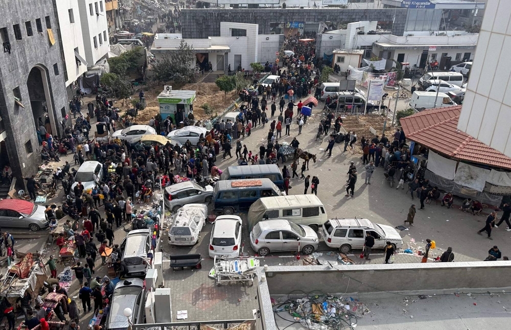 Displaced Palestinians gather in the yard of Gaza's Shifa hospital on Dec. 10.