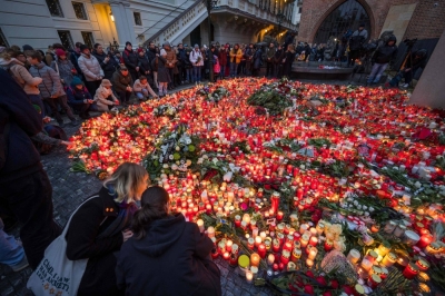 Well-wishers light candles as people mourn the lives lost in Thursday's mass shooting, outside Charles University in Prague on Friday. 