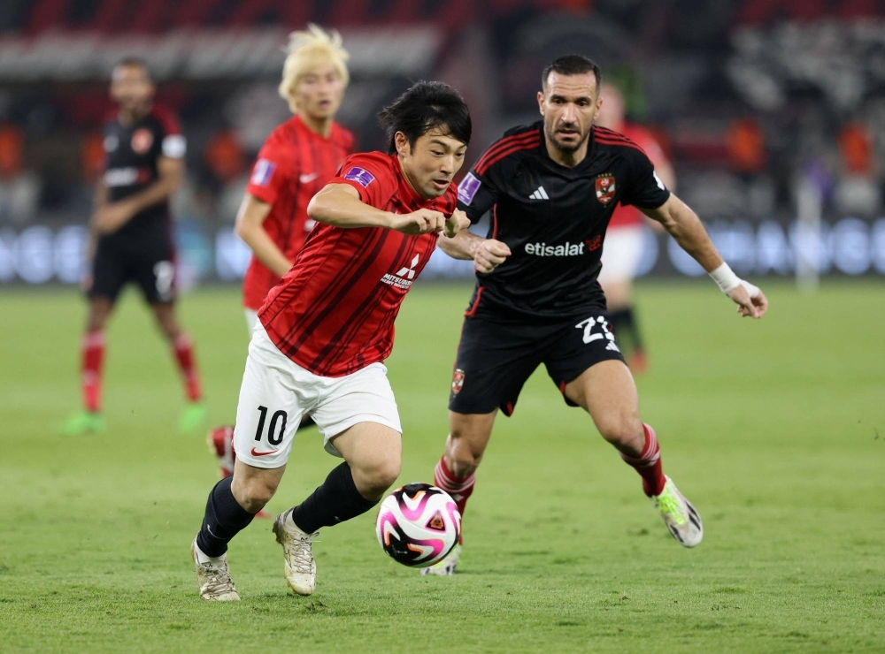 Urawa Reds' Shoya Nakajima fends off Al Ahly's Ali Maaloul during the third-place game of the Club World Cup on Friday in Jeddah, Saudi Arabia. 