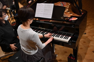 Hiroko Higashino, who was born with three fingers on her right hand, plays an AI-powered piano during a rehearsal for a Christmas concert in Tokyo on Wednesday. 