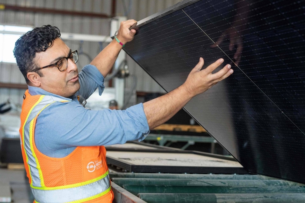 We Recycle Solar Chief Executive Officer Adam Saghei shows damaged solar panels to be recycled at the We Recycle Solar plant in Yuma, Arizona.