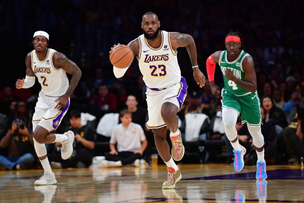 Los Angeles Lakers forward LeBron James (23) moves the ball up court during the first half of a game against Boston Celtics in Los Angeles on Monday.