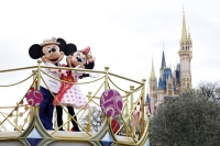 Disney characters perform on a float during a parade at Tokyo Disneyland in January. | Bloomberg