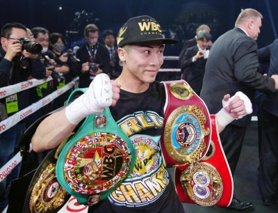 Japanese boxer Naoya Inoue displays his title belts after becoming the undisputed super bantamweight champion on Tuesday evening. 