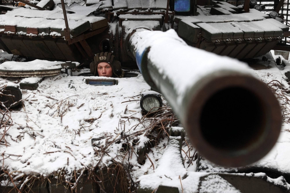 A Ukrainian soldier looks out from a tank as he holds his position near to the town of Bakhmut, in Ukraine's Donetsk region, on Dec. 13.